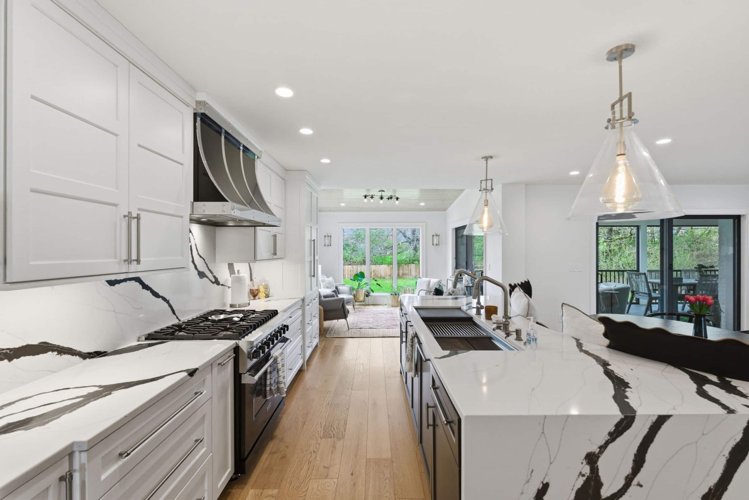 A finished Homes Made kitchen with a black-and-white veined marble waterfall island